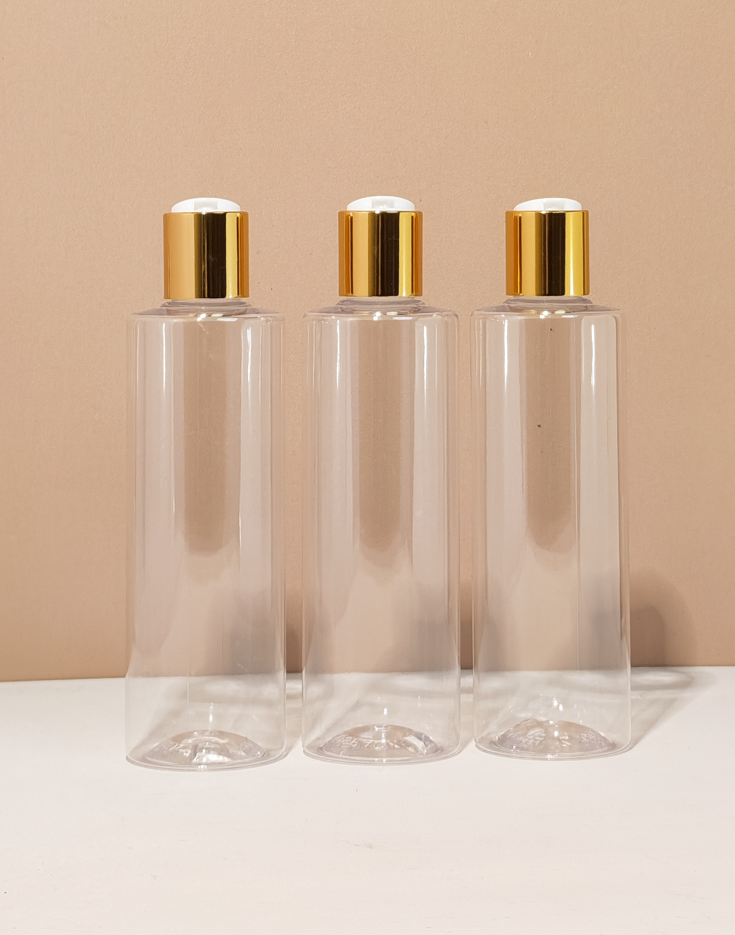 250Ml Tall Pet Bottle With Gold Press Cap